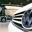 The logo of German carmaker Volkswagen VW is seen on a vehicles grill in front of a VW Constellation truck, background, during preparations for the 61st IAA International Motor Show Commercial Vehicles in Hanover, northern Germany, on Tuesday, Sept. 19, 2006. The IAA Commercial Vehicles gathering 1,370 exhibitors from 38 countries opens its gates to the public from Thursday, Sept. 21 to Thursday Sept. 28, 2006. (AP Photo/Fabian Bimmer)