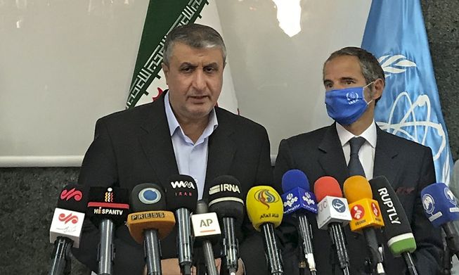 Head of Iran's nuclear agency, Mohammad Eslami (left), speaks to the media alongside Director General of the International Atomic Energy Agency, Rafael Grossi, following their meeting in Tehran on Sunday