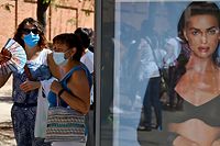 Teachers and nonacademic personnel queue to undergo PCR tests outside the Virgen de la Paloma high school, ahead of the reopening of schools for a new academic year amid the coronavirus pandemic, in Madrid on September 2, 2020. (Photo by Gabriel BOUYS / AFP)