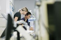 Two young female technicians working in a hospital workshop
