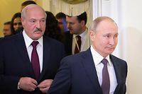 (FILES) This file photo taken on December 20, 2019 shows Russian President Vladimir Putin (R) followed by Belarusian President Alexander Lukashenko (L), entering a meeting hall during the Supreme Eurasian Economic Council, in Saint Petersburg. - Belarusian President Alexander Lukashenko discussed the protests shaking his country with Russian counterpart Vladimir Putin on August 15, Belarusian state news agency Belta reported. (Photo by Mikhail KLIMENTYEV / Sputnik / AFP)