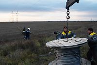 Eletricistas ucranianos arranjam uma linha elétrica danificada nos arredores de Kherson, a 19 de novembro.