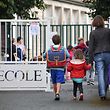 (FILES) In this file photo taken on September 4, 2017 Pupils arrive at a primary school on the first day of the new school year, in La Rochelle, western France. - French President Emmanuel Macron said during a televised speech on June 14, 2020 that all French schools, except high schools, would fully reopen from June 22, a move that will allow more parents to return to work and give students at least a few days with their teachers before the summer break. (Photo by XAVIER LEOTY / AFP)