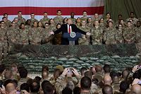 (FILES) In this file photo taken on November 28, 2019, US President Donald Trump speaks to the troops during a surprise Thanksgiving day visit at Bagram Air Field in Afghanistan. - President Donald Trump has shattered through norms and niceties on the world stage in his nearly three years in office. Entering an election year, Trump is unlikely to slow down as he seeks what has largely eluded him -- a headline-grabbing victory. The tycoon turned president closes 2019 with a new stride after what was perhaps his most unambiguous achievement -- US commandos' raid that killed the leader of the Islamic State extremist group. But the year was also full of tosses and turns for Trump. On his ambition to end the war in Afghanistan, he startled Washington by inviting the Taliban to talks but then declared the talks dead before resuming them. (Photo by Olivier Douliery / AFP)