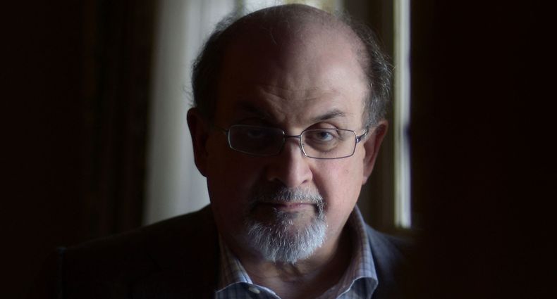 In this file photo taken on April 19, 2013, British author Salman Rushdie, poses for a portrait during 'Midnight's Children' press day on April 19, 2013 in Los Angeles, California. - It has been reported that Rushdie was attacked on stage today during an event in New York. (Photo by Joe KLAMAR / AFP)