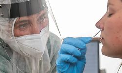 A health worker takes a swab sample from a woman to test for the COVID-19 coronavirus at the triage center 'Centrum' at the Sint-Vincentiusziekenhuis, in Antwerp on July 30, 2020. - The Covid-19 contamination numbers are on the rise, especially in the Antwerp city center. The National Security Council has announced more strict coronavirus measures, that went into effect yesterday, in an attempt to try and keep the contamination level as low as possible. (Photo by JONAS ROOSENS / Belga / AFP) / Belgium OUT