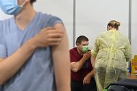 A man receives a dose of a vaccine against the coronavirus disease (Covid-19) in one of vaccination centers in the Ukrainian capital of Kiev on November 9, 2021. (Photo by Sergei SUPINSKY / AFP)