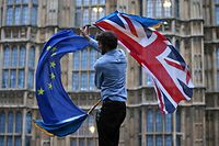 (FILES) In this file photo taken on June 28, 2016 A man waves both a Union flag and a European flag together on College Green outside The Houses of Parliament at an anti-Brexit protest in central London on June 28, 2016. - British Prime Minister Boris Johnson announced Wednesday that the suspension of parliament would be extended until October 14 -- just two weeks before the UK is set to leave the EU -- enraging anti-Brexit MPs. (Photo by JUSTIN TALLIS / AFP)