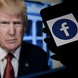 (File) In this file illustration photo taken on May 4, 2021, the Facebook logo is displayed on a phone screen in Arlington, Virginia, with the official portrait of former U.S. President Donald Trump in the background.  - Social networking giant Meta announced on Wednesday, January 25, that in the coming weeks, "end the stop" Donald Trump's Facebook and Instagram accounts are two years after the former U.S. president was banned following his attack on the Capitol. (Photo credit: Olivier DOULIERY/AFP)