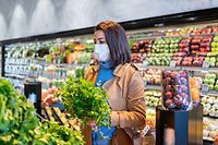 Woman With Protective Face Mask Buying Vegetables At Supermarket In The New Normal