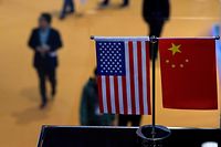 (FILES) This file picture taken on November 6, 2018 shows a Chinese and US flag at a booth during the first China International Import Expo (CIIE) in Shanghai. - With the eyes of the world on Washington for the high-stakes trade talks on May 11-12, 2019 between China and the United States, none will be more focused than those of Chinese exporters who are increasingly worried about the impact of more tariffs. (Photo by JOHANNES EISELE / AFP)