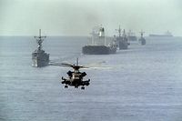 (FILES) In this file photo taken on October 22, 1987, a US Navy minesweeping helicopter leads the way for the 12th US reflagged Kuwaiti tanker convoy, as two tankers, Gass Prince and Ocean City, are being escorted by four US war ships (Haws, Ford, Raleigh and Standley) and the US helicopter carrier Guadacanal, heading out of the Gulf three days after US ships bombed two Iranian oil platforms, amid the Tanker War. - On September 22, 1980, Iraqi dictator Saddam Hussein sent troops into neighbouring Iran, starting an eight-year war in which hundreds of thousands were killed. (Photo by Norbert SCHILLER / AFP)