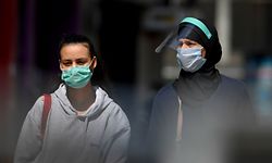 People wearing protective face masks walk in Rue Neuve, a shopping street in Brussels centre on May 9, 2020, amid the country's lockdown to stem the spread of the COVID-19 outbreak caused by novel coronavirus. - Shops in Belgium will reopen on May 11, 2020. (Photo by JOHN THYS / AFP)