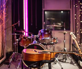 Acoustic guitar on the background of a recording Studio. Room for musicians rehearsals. The concept of musical creativity and show business.