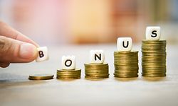 Yearly Bonus concept / hand holding words of bonus on stack coins staircase for Encouragement Morale on the table office company