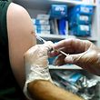 (Files) In this file photo taken August 10, 2022, a pharmacist administers a dose of Imvanex, a vaccine to protect against Monkeypox virus, at a pharmacy in Lille, northern France.  - They've traveled miles and crossed borders: The monkeypox vaccination campaign has taken an unexpected turn in Europe, with hundreds of people going abroad in search of a dose due to lack of quick access to a vaccine at home.  (Photo by Francois Le Presti/AFP)