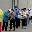 People queue to be tested for the Covid-19 coronavirus at a swab collection site in Beijing on June 15, 2022. (Photo by Noel Celis / AFP)