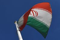 The Iranian national flag is seen outside the International Atomic Energy Agency (IAEA) headquarters during the agency's Board of Governors meeting in Vienna on March 1, 2021. (Photo by JOE KLAMAR / AFP)