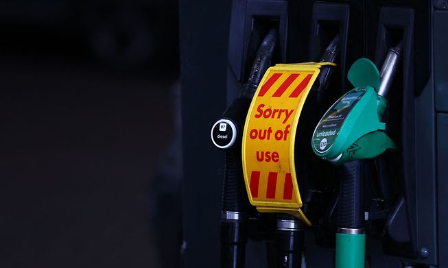 An "out of use" sign covers a diesel fuel pump at a petrol station off of the M3 motorway near Fleet, west of London, on Sunday
