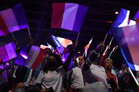 Supporters wave French flags during the meeting of French conservative party Les Republicains (LR) presidential candidate Valerie Pecresse at the Zenith de Paris, in Paris, on February 13, 2022, ahead of the April 2022 French presidential election. (Photo by Alain JOCARD / AFP)