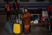 TOPSHOT - Ukrainian refugees wait to board a train en route to Warsaw at the rail station in Przemysl, near the Polish-Ukrainian border, on March 31, 2022, following Russia's military invasion launched on Ukraine. - The United Nations said on March 31, 2022 the refugee exodus from Ukraine was a "massive humanitarian crisis" that was growing by the second, after another 40,000 fled the country in 24 hours. The United Nations said on March 31 the refugee exodus from Ukraine was a "massive humanitarian crisis" that was growing by the second, after another 40,000 fled the country in 24 hours. (Photo by Angelos Tzortzinis / AFP)