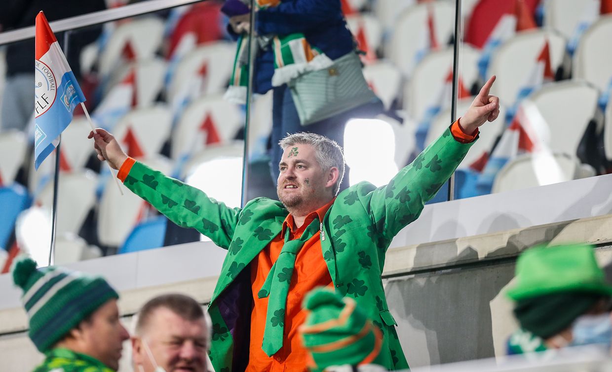 This Irish fan holds the Luxembourg flag in his right hand.