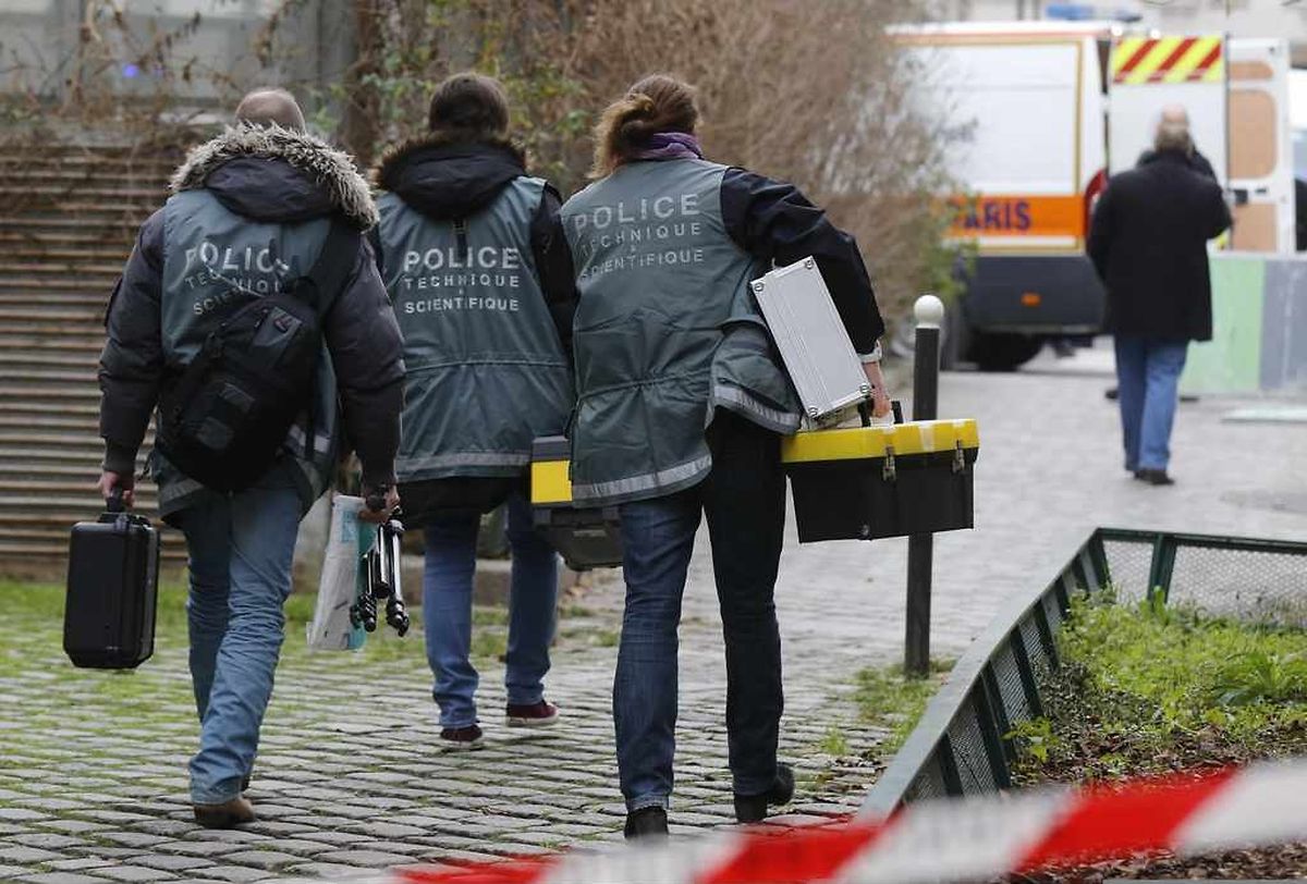 Police investigators are seen at the scene after a shooting at the Paris offices of Charlie Hebdo, a satirical newspaper, January 7, 2015. Eleven people were killed and 10 injured in shooting at the Paris offices of the satirical weekly Charlie Hebdo, already the target of a firebombing in 2011 after publishing cartoons deriding Prophet Mohammad on its cover, police spokesman said. Five of the injured were in a critical condition, said the spokesman. Separately, the government said it was raising France's national security level to the highest notch. REUTERS/Jacky Naegelen (FRANCE - Tags: CRIME LAW MEDIA)