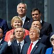 (Front row, LtoR) Belgium's Prime Minister Charles Michel, NATO Secretary General Jens Stoltenberg, US President Donald Trump, Britain's Prime Minister Theresa May and Estonia's Prime Minister Juri Ratas and other NATO leaders watch a helicopter flyover as they attend the opening ceremony of the NATO (North Atlantic Treaty Organization) summit, at the NATO headquarters in Brussels, on July 11, 2018.  / AFP PHOTO / GEOFFROY VAN DER HASSELT