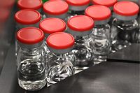 Capped vials are being pictured during filling and packaging tests for the large-scale production and supply of the University of Oxford�s COVID-19 vaccine candidate, AZD1222, conducted on a high-performance aseptic vial filling line on September 11, 2020 at the Italian biologics� manufacturing facility of multinational corporation Catalent in Anagni, southeast of Rome, during the COVID-19 infection, caused by the novel coronavirus. - Catalent Biologics� manufacturing facility in Anagni, Italy will serve as the launch facility for the large-scale production and supply of the University of Oxford�s Covid-19 vaccine candidate, AZD1222, providing large-scale vial filling and packaging to British-Swedish multinational pharmaceutical and biopharmaceutical company AstraZeneca. (Photo by Vincenzo PINTO / AFP)