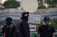 Protesters gathers on a road in the Admiralty area in Hong Kong on October 1, 2019, as the city observes the National Day holiday to mark the 70th anniversary of communist China's founding. - Strife-torn Hong Kong on October 1 marked the 70th anniversary of communist China's founding with defiant "Day of Grief" protests and fresh clashes with police as pro-democracy activists ignored a ban and took to the streets across the city. (Photo by Nicolas ASFOURI / AFP)