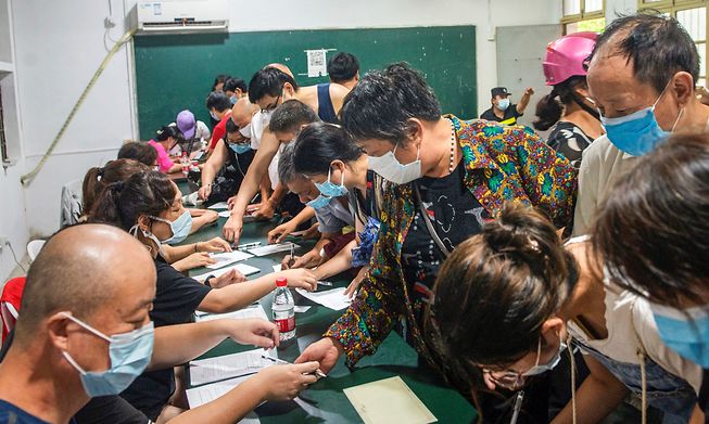 People register to receive the Covid-19 vaccine on Tuesday in Ningbo, where authorities have closed part of the world's third-busiest port.