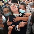 TOPSHOT - The mother (C) of Khant Nyar Hein reacts at his funeral in Yangon on March 16, 2021, after the first year medical student was shot dead during a crackdown by security forces on protesters taking part in a demonstration against the military coup. (Photo by STR / AFP)