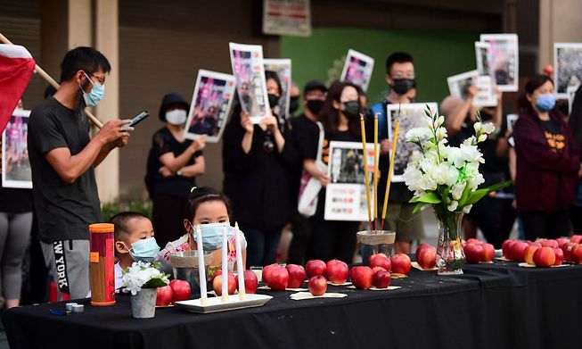 Apples line a table in homage to the now shut down Hong Kong Apple Daily newspaper 