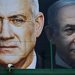 (FILES) In this file photo taken on February 17, 2020 (FILES) A file photo taken on February 17, 2020 shows an election banner for the Israeli Blue and White political alliance (Kahol Lavan) with the face of (L to R) its leader retired army general Benny Gantz and Prime Minister Benjamin Netanyahu, hanging in Ramat Gan. - Israeli Prime Minister Benjamin Netanyahu and his former rival, parliament speaker Benny Gantz, agreed to form an emergency unity government on April 20, 2020, ending the worst political crisis in the country's history. (Photo by JACK GUEZ / AFP)