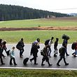 (FILES) This file photo taken on November 09, 2015 shows migrants walking on the road after crossing the Austrian-German border near the Bavarian village of Wegscheid, southern Germany. 
As Germany struggles to cope with the arrival of more than one million refugees, the country's rural communities could hold the key to integrating the newcomers and even stand to benefit themselves in face of dwindling populations, experts say. / AFP / CHRISTOF STACHE