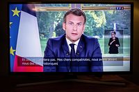 French President Emmanuel Macron is seen on a television screen in Paris on June 14, 2020 as he addresses the nation from the Elysee Palace during a televised speech, broadcast by French tv channel TF1. (Photo by Thomas SAMSON / AFP)