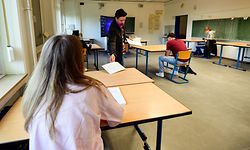 A teacher works in a classroom with a few pupils preparing for their Abitur exam at the the Phoenix Gymnasium secondary school in Dortmund, western Germany, on April 23, 2020, as social distancing is practiced amid the novel coronavirus COVID-19 pandemic. - Students preparing for the Abitur high school graduation with exams taking place in May are allowed to turn back to school in small groups with six students in a classroom. (Photo by Ina FASSBENDER / AFP)