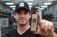 Joseph Oliver, CEO of British-based cannabidiol firm LDN CBD, poses  outside Chelsea Health store  in London on August 16, 2021. - Britain's legal cannabis market has boomed during the coronavirus pandemic to become the second biggest after the United States, as consumers rushed to alleviate Covid-linked symptoms, industry experts say. (Photo by ADRIAN DENNIS / AFP) / TO GO WITH AFP STORY JEAN-BAPTISTE OUBRIER