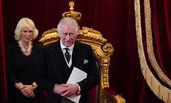 TOPSHOT - Britain's Camilla, Queen Consort (L)reacts as Britain's King Charles III smiles during a meeting of the Accession Council inside St James's Palace in London on September 10, 2022, to proclaim Charles as the new King. - Britain's Charles III was officially proclaimed King in a ceremony on Saturday, a day after he vowed in his first speech to mourning subjects that he would emulate his "darling mama", Queen Elizabeth II who died on September 8. (Photo by Jonathan Brady / POOL / AFP)