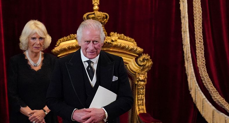 TOPSHOT - Britain's Camilla, Queen Consort (L)reacts as Britain's King Charles III smiles during a meeting of the Accession Council inside St James's Palace in London on September 10, 2022, to proclaim Charles as the new King. - Britain's Charles III was officially proclaimed King in a ceremony on Saturday, a day after he vowed in his first speech to mourning subjects that he would emulate his "darling mama", Queen Elizabeth II who died on September 8. (Photo by Jonathan Brady / POOL / AFP)