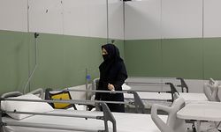 An Iranian health inspector checks a makeshift hospital set up inside the Iran Mall, northwest of Tehran, on March 21, 2020 amid the coronavirus outbreak. - Iran said that 123 more people had died from coronavirus, raising the official death toll to 1,556 in the Islamic republic, one of the world's worst affected countries. (Photo by STR / AFP)