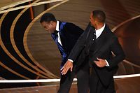 US actor Will Smith (R) slaps US actor Chris Rock onstage during the 94th Oscars at the Dolby Theatre in Hollywood, California on March 27, 2022. (Photo by Robyn Beck / AFP)