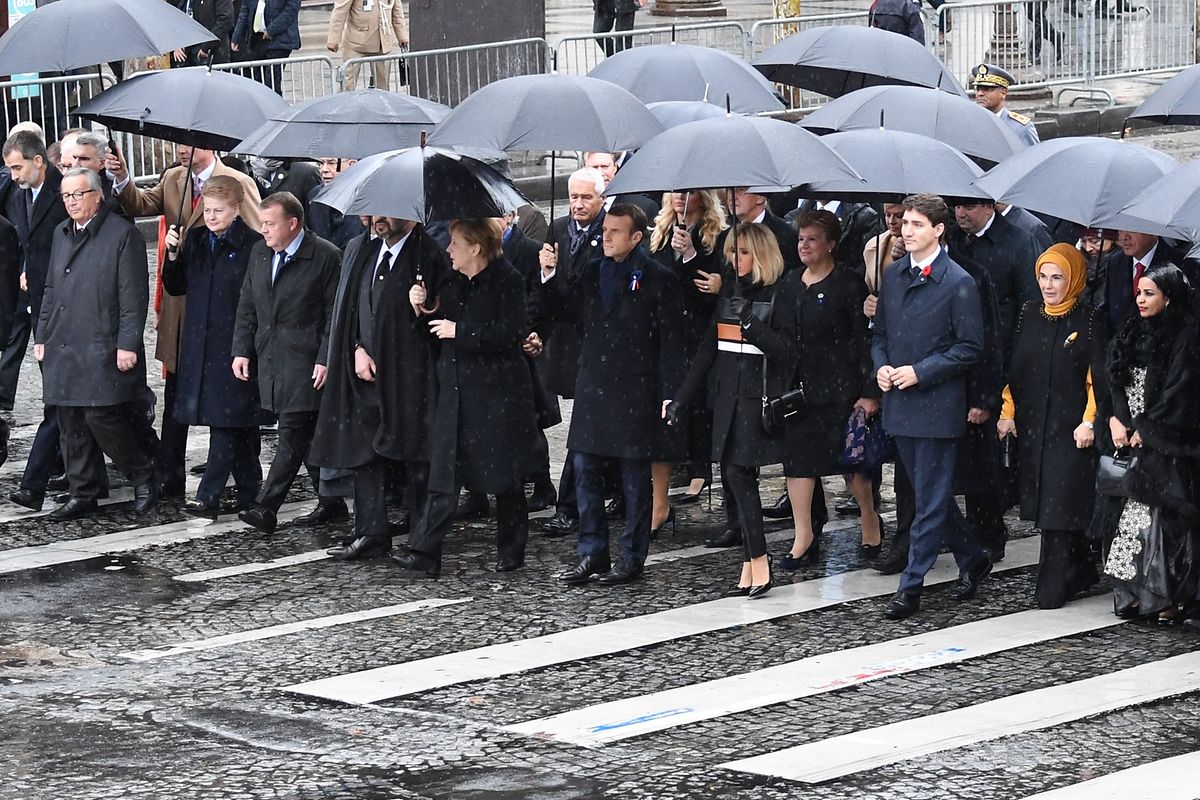 (FromL) President of the European Commission Jean-Claude Juncker, Lithuania's President Dalia Grybauskaite, Denmark's Prime Minister Lars Lokke Rasmussen, Morocco's Prince Moulay Hassan, Moroccan King Mohammed VI, German Chancellor Angela Merkel, French President Emmanuel Macron and his wife Brigitte Macron, Canadian Prime Minister Justin Trudeau, Turkish President's wife Emine Erdogan and Niger's President's Lalla Malika Issoufou arrive at the Arc de Triomphe in Paris on November 11, 2018 to attend a ceremony as part of commemorations marking the 100th anniversary of the 11 November 1918 armistice, ending World War I. (Photo by Eric FEFERBERG / AFP)