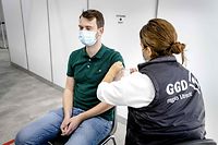 A health worker gives a vaccine shot against Covid-19 to a man in Ultrecht on October 8, 2021. - The vaccination location at the Jaarbeurs has been put back into use. (Photo by Sem van der Wal / ANP / AFP) / Netherlands OUT