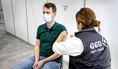 A health worker gives a vaccine shot against Covid-19 to a man in Ultrecht on October 8, 2021. - The vaccination location at the Jaarbeurs has been put back into use. (Photo by Sem van der Wal / ANP / AFP) / Netherlands OUT