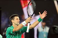 Serbia's Novak Djokovic celebrates after victory against Canada's Milos Raonic during their men's singles quarter-final match on day nine of the Australian Open tennis tournament in Melbourne on January 28, 2020. (Photo by DAVID GRAY / AFP) / IMAGE RESTRICTED TO EDITORIAL USE - STRICTLY NO COMMERCIAL USE