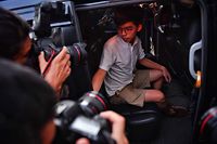 Pro-democracy activist Joshua Wong leaves the Eastern Magistrates� Courts after being released on bail in Hong Kong on August 30, 2019. - Prominent democracy activists including a lawmaker were arrested on August 30 in a dragnet across Hong Kong -- a move described by rights groups as a well-worn tactic deployed by China to suffocate dissent ahead of key political events. (Photo by Lillian SUWANRUMPHA / AFP)