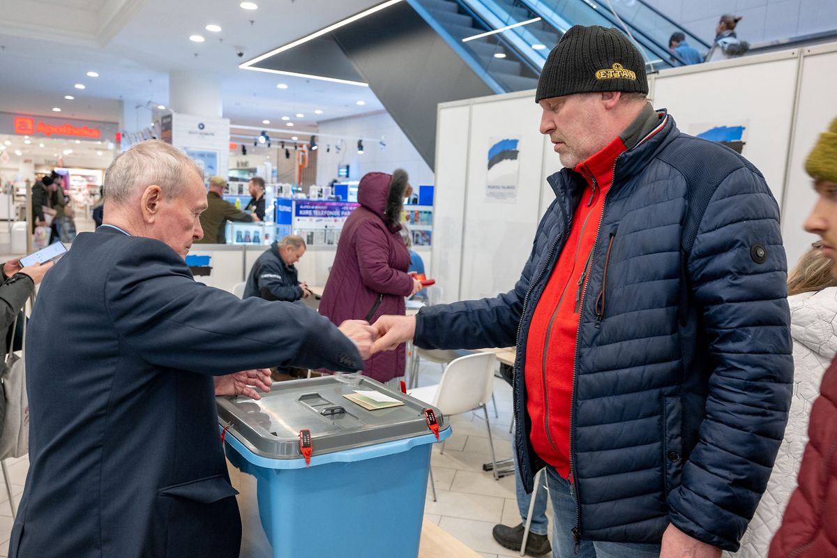 People cast their vote in a polling station at a shopping centre in Tallinn, Estonia