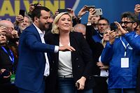 Italian Deputy Prime Minister and Interior Minister Matteo Salvini (L) and President of the French far-right Rassemblement National (RN) party Marine Le Pen react on stage at a rally of European nationalists ahead of European elections on May 18, 2019, in Milan. - The Milan rally hopes to see leaders of 12 far-right parties marching towards their conquest of Brussels after European parliamentary elections held between May 23 and 26, 2019. The headliners of Italy's League France's National Rally (RN) want their Europe of Nations and Freedom (ENF) group to become the third largest in Brussels. (Photo by Miguel MEDINA / AFP)