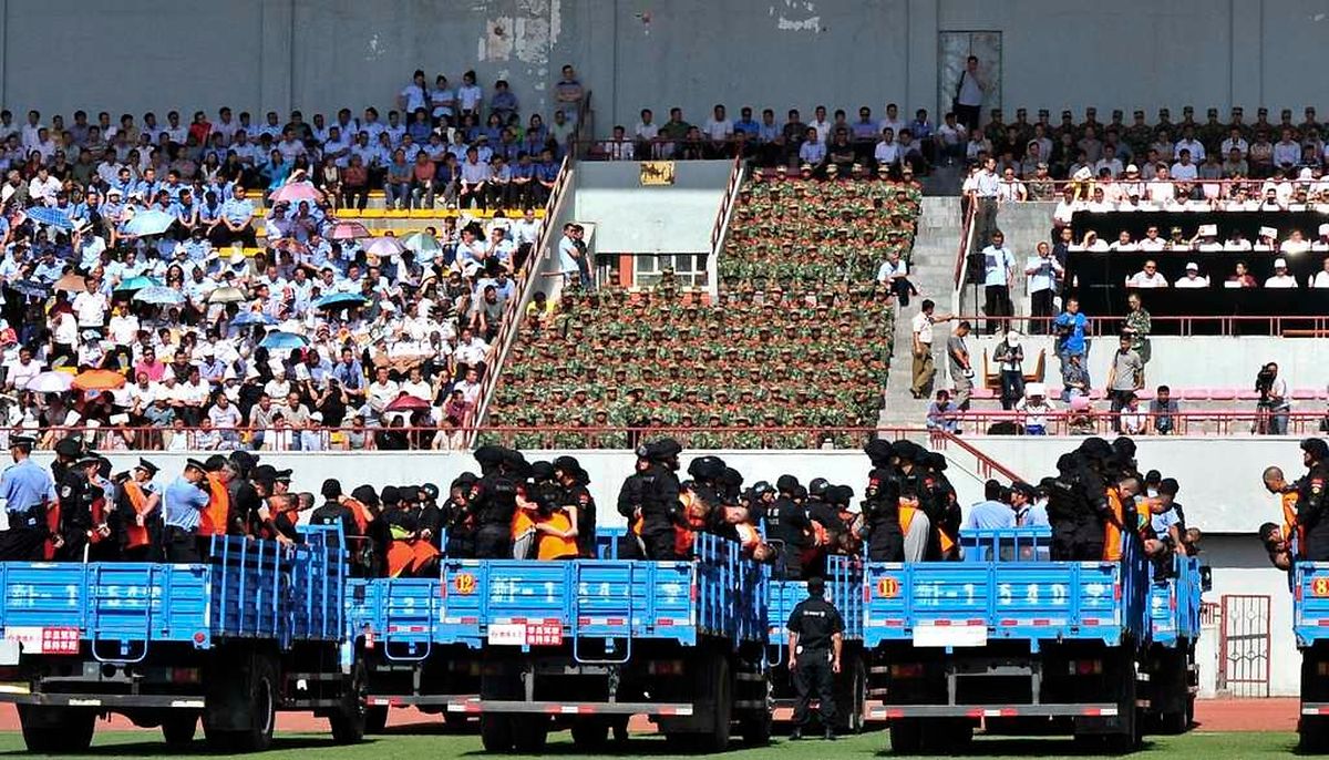 Trucks carrying criminals and suspects are seen during a mass sentencing rally at a stadium in Yili, Xinjiang Uighur Autonomous Region May 27, 2014. Local officials in China's western Xinjiang region held the public rally for the mass sentencing of criminals on Tuesday, handing out judgements for 55 people and at least three death sentences for crimes such as "violent terrorism", state media said. Picture taken May 27, 2014. REUTERS/Stringer (CHINA - Tags: CIVIL UNREST CRIME LAW POLITICS) CHINA OUT. NO COMMERCIAL OR EDITORIAL SALES IN CHINA
